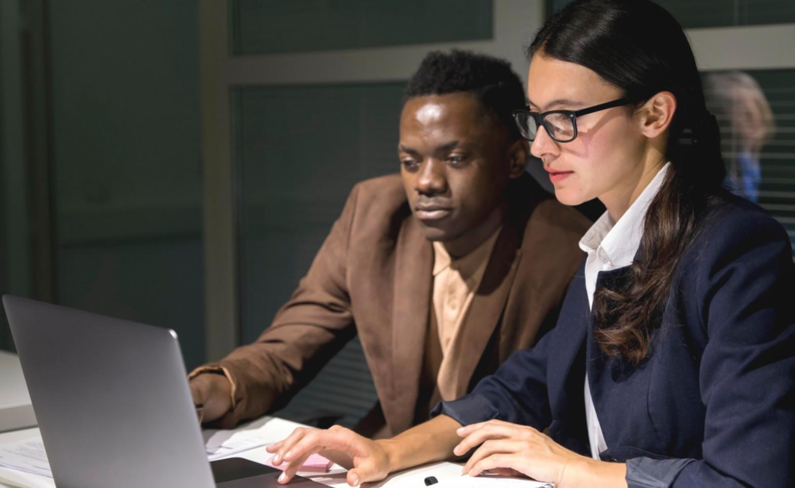 Business owner reviewing financial dashboard on computer showing real-time cash flow data and transaction summaries